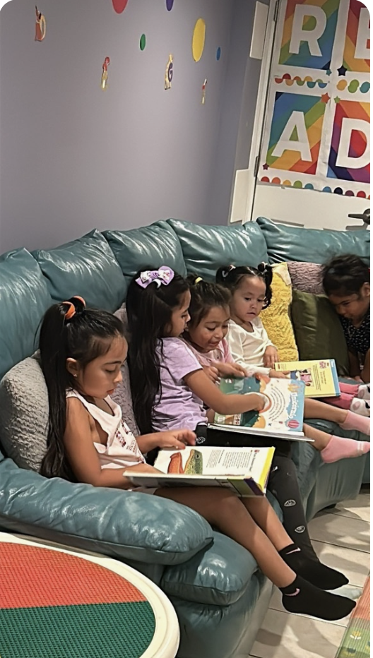 Children enjoying books together in the daycare reading area